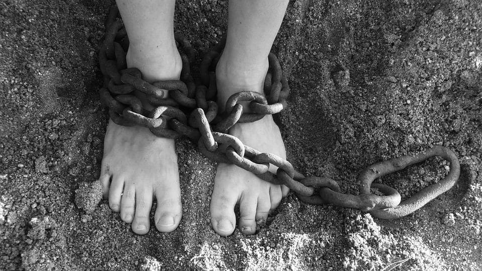 Two feet wrapped in chains used to illustrate the issue of false imprisonment in california