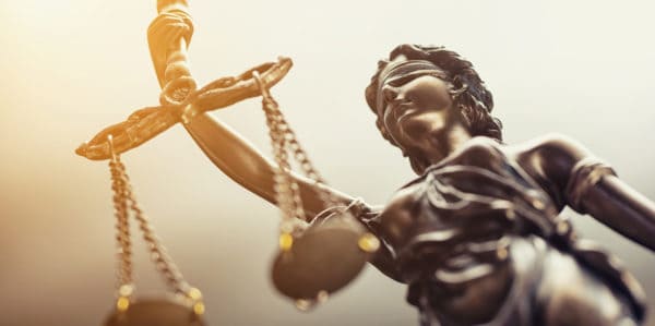 A statue of Lady Justice to represent the criminal court system for an article titled What is a joint trial