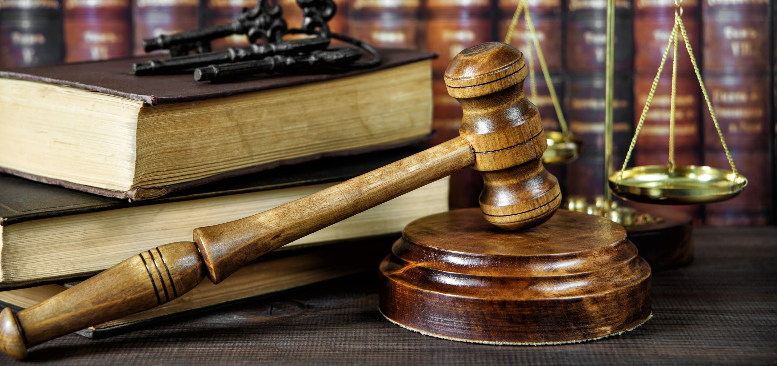 Scales, a gavel and legal books that could possibly hold the answer to "what is contempt of court?"