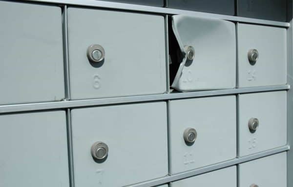 A broken mail box that was possibly cracked open for theft, used to illustrate 530.5(e) (PC)