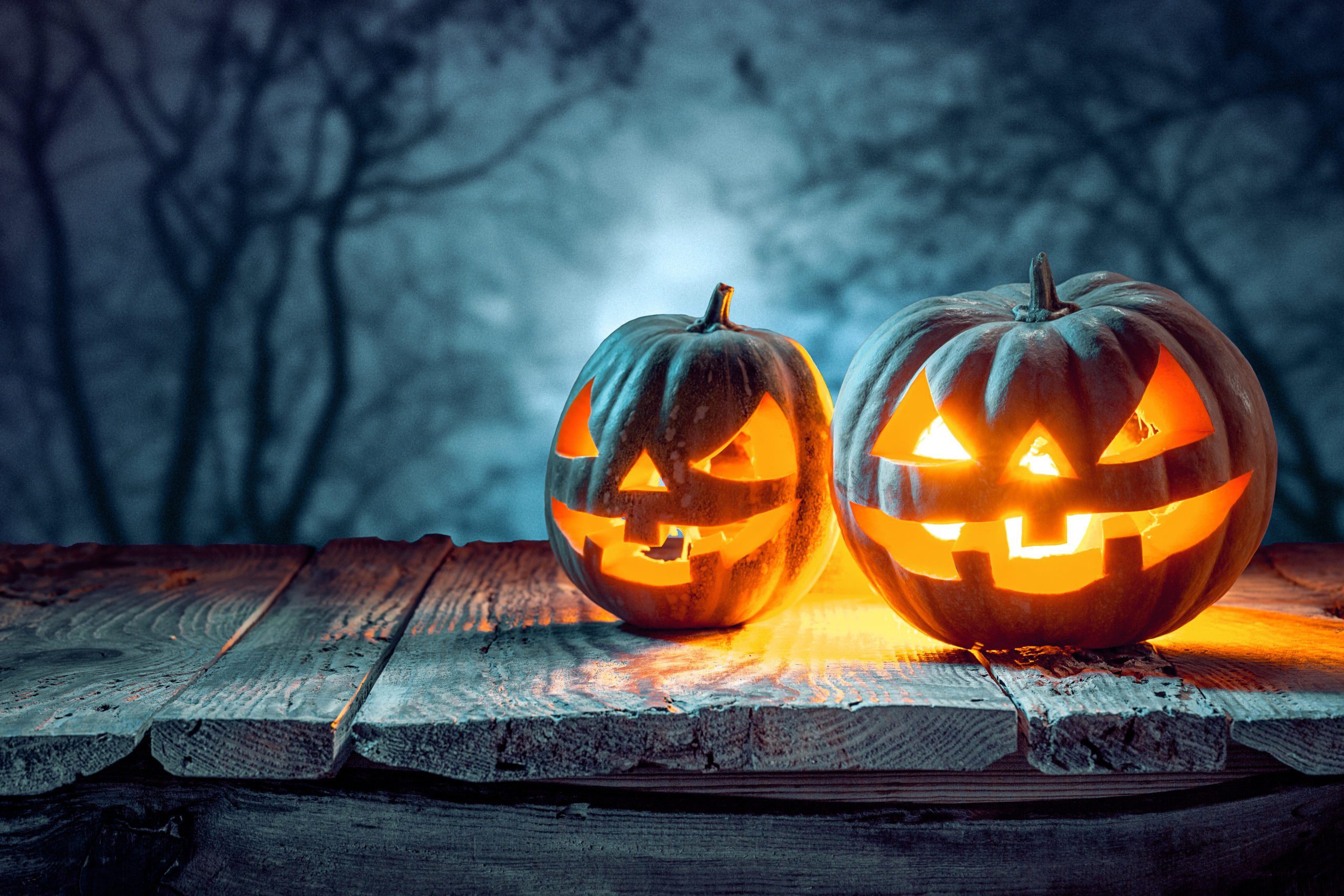 Spooky smiling jack-o-lanterns illustrating the issue of California sex offender laws on halloween