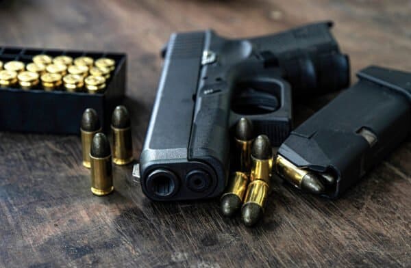 The Story of Alec Baldwin's Rust Trial 1 A gun with ammunition to illustrate Alec Baldwin's charges being dismissed in the Rust shooting case.